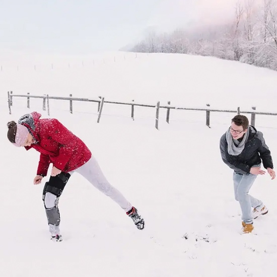 A man wearing a C-Brace is enjoying a snowfight with his friend in New York and New Jersey