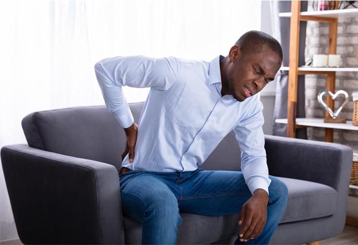 man holding his back in pain