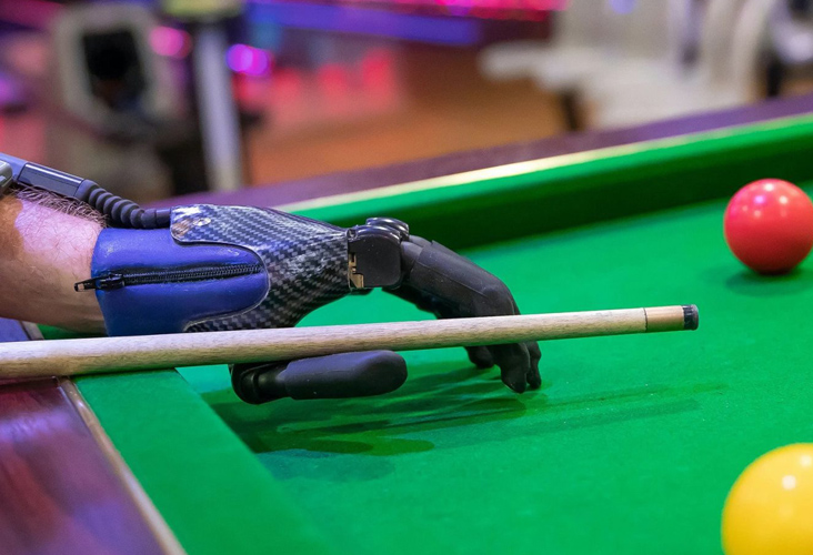 Prosthetic for hand, person playing pool